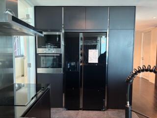 Modern kitchen with black appliances and cabinets