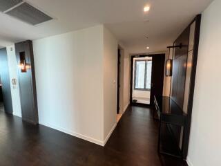 Modern hallway with dark wood flooring and contemporary lighting fixtures