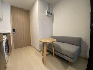 Cozy entryway with a small sofa and round table