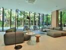 Spacious modern living room with large windows and outdoor view