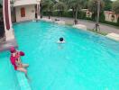 Swimming pool area with people swimming