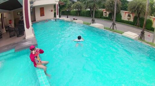 Swimming pool area with people swimming