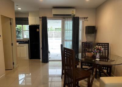 Dining area with table and chairs, view of kitchen and outdoor space