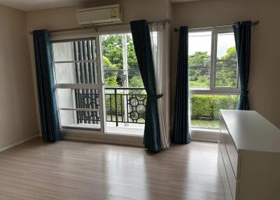 Spacious bedroom with large windows and balcony access