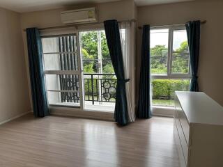 Spacious bedroom with large windows and balcony access