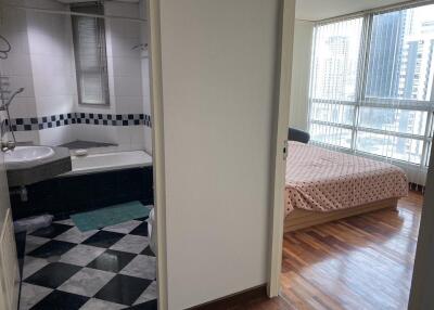 View of bedroom and bathroom in modern apartment