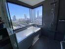 Bathroom with a large window and a city view