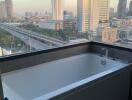 Bathroom with a large bathtub and a city view