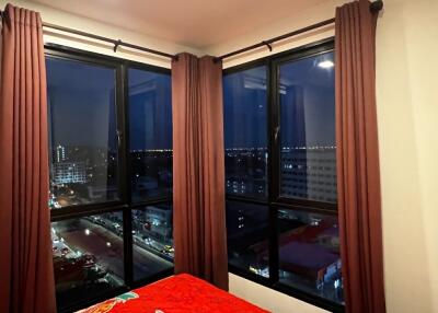 Bedroom with large windows and night city view