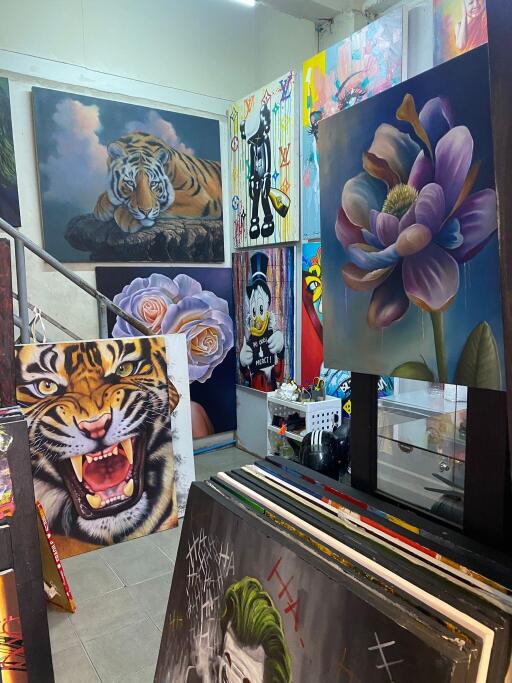 Colorful art studio with various paintings