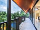 Spacious balcony with overhang roof and glass sliding doors