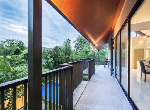 Spacious balcony with overhang roof and glass sliding doors