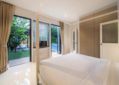 Spacious bedroom with large windows and garden view