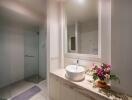 Modern bathroom with a vanity, sink, and glass shower