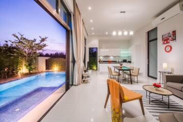 Modern living area with open kitchen and pool view