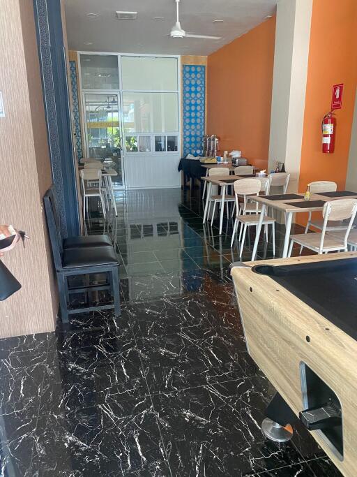 Dining area with tables, chairs, and a pool table