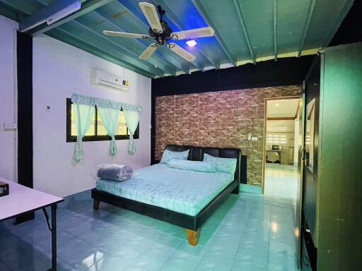 Bedroom with bed, air conditioner, ceiling fan, and blue tile floor