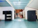 Spacious living area with open ceiling design and blue tiles