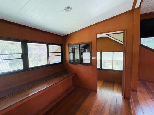 Main living area with large windows and wooden interior