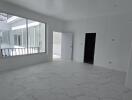 Unfurnished room with large windows and marble floor