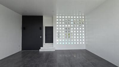 Living room with modern design featuring glass block wall