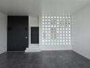 Living room with modern design featuring glass block wall