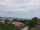 Scenic view of neighborhood with greenery and distant water body