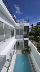 Outdoor area with pool and spiral staircase