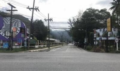 Street view with buildings, utility poles, and billboards