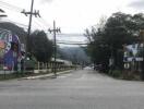 Street view with buildings, utility poles, and billboards