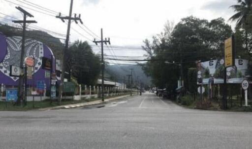 Street view with buildings, utility poles, and billboards