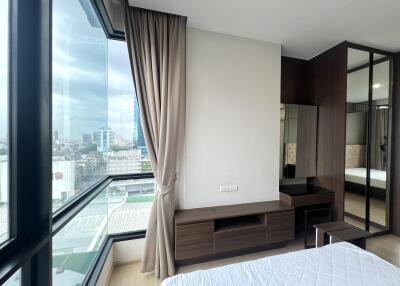 Modern bedroom with large windows and city view