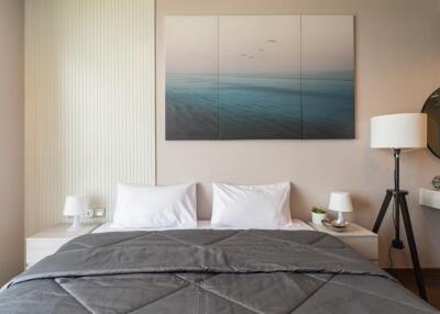 Modern bedroom with a double bed, contemporary wall art, and bedside lamps