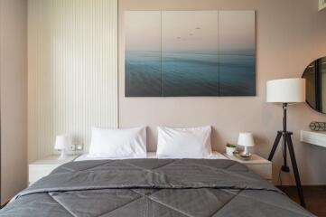 Modern bedroom with a double bed, contemporary wall art, and bedside lamps