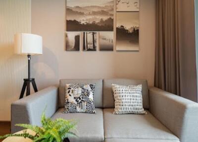 Modern living room with a grey sectional sofa and wall art