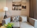 Modern living room with a grey sectional sofa and wall art