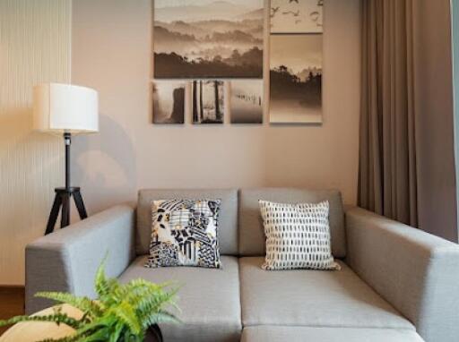 Modern living room with a grey sectional sofa and wall art