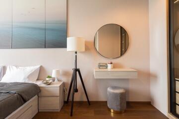 Modern bedroom interior with bedside table, lamp, mirror, and stool