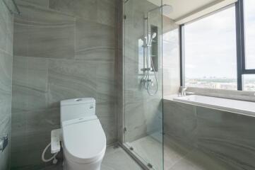 Modern bathroom with shower, toilet, and window