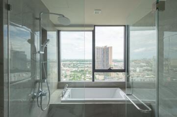 Modern bathroom with large window and city view