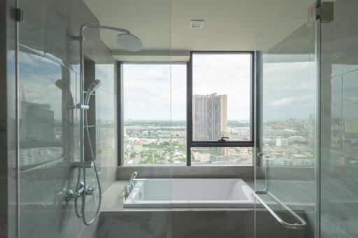 Modern bathroom with large window and city view