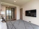 Modern bedroom with wall-mounted TV and glass-door closet