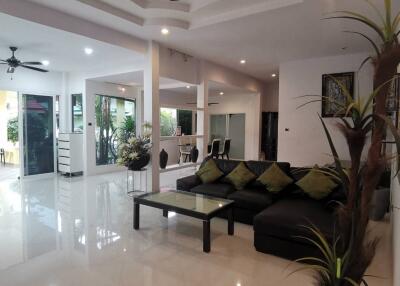 Modern living room with ceiling fans and large windows