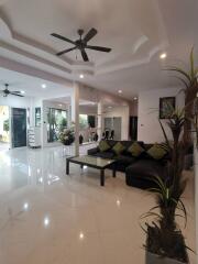 Modern living room with ceiling fans and large windows