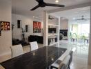 Modern dining area with black dining table and white chairs