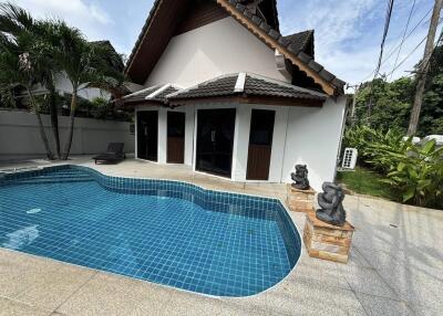 Swimming pool area in front of a house