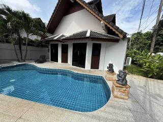 Swimming pool area in front of a house