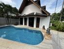 Swimming pool area in front of a house