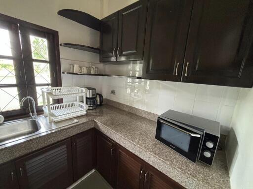 Cozy kitchen with countertops, cabinets, and kitchen appliances