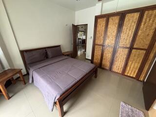 Cozy bedroom with wooden furniture and a double bed